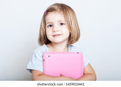 Education, Elementary School, Technology, Advertisement And Children Concept -  Funny Schoolchild Girl With Tablet,iPad,pc And Notebook, Diary On A White Background. Girl Ready To Study. Copy Space