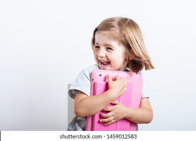 Education, Elementary School, Technology, Advertisement And Children Concept -  Funny Schoolchild Girl With Tablet,iPad,pc And Notebook, Diary On A White Background. Girl Ready To Study. Copy Space