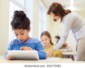 Education, Elementary School, Technology And Children Concept - Little Student Girl With Tablet Pc Over Classroom And Teacher Background