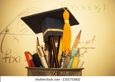 Education Graduate study concept: Graduation hat on pencils with formula arithmetic equation graph on projecter screen at university classroom. Ideas for knowledge learning success and Back to School
