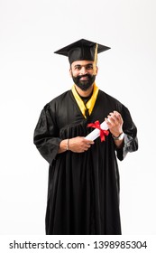 Education, Graduation And People Concept - Happy Indian Male Graduate Student In Mortarboard And Bachelor Gown