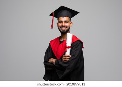 education, graduation and people concept - happy indian male graduate student in mortar board and bachelor gown with diploma over grey background - Shutterstock ID 2010979811