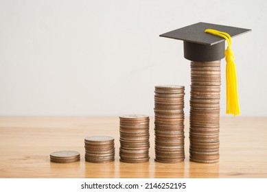 Education Growth And Development From Scholarship, Money Saving Or Loan For Education Abroad Concept. Coins Stacked Graph Growing Up And Graduation Hat On Wooden Table Background Copy Space.