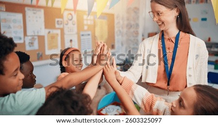 Education, high five or learning with students and teacher in classroom of school for child development. Growth, knowledge or success with smile of woman with kids in lesson for course or study