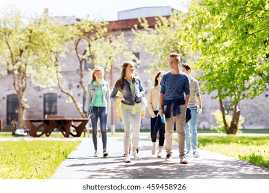 education, high school, communication and people concept - group of happy teenage students walking outdoors