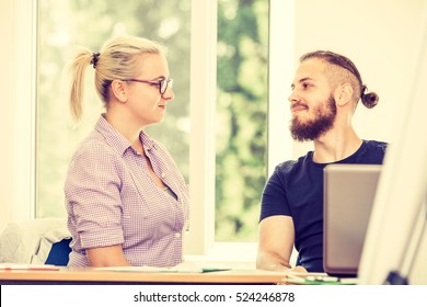 Education, High School Concept. Two Students Male And Female Talking Doing Homework In Classroom