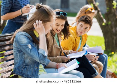 education, high school and people concept - group of happy teenage students with notebooks learning at campus yard - Shutterstock ID 496115566