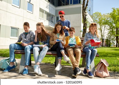 Education, High School And People Concept - Group Of Happy Teenage Students With Notebooks Learning At Campus Yard