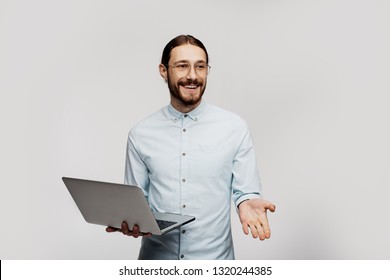 Education, High School, Technology And People Concept - Smiling Teacher With Notepad, Laptop Computer Standing In Front Of Students And Showing Something On White Board In Classroom