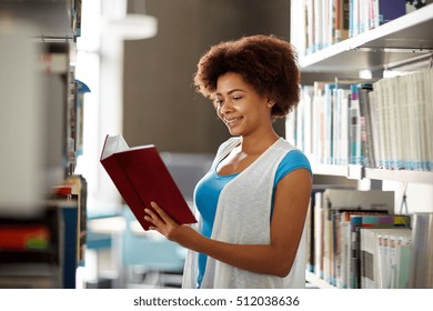 education, high school, university, learning and people concept - happy smiling african american student girl reading book at library