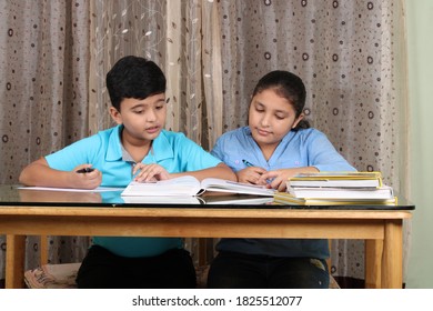 Education At Home Concept - 2 Cute Indian/Asian Kids Studying/doing Homework.