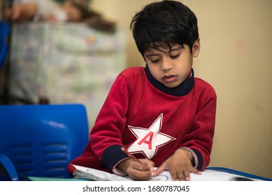Education at home concept    Cute little Pakistan/Asian boy studying completing home work study
