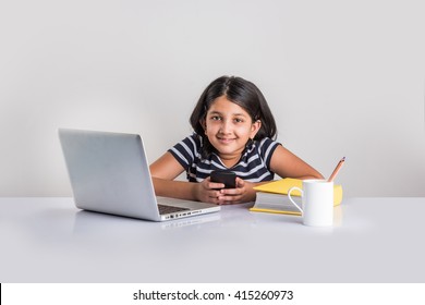 Education At Home Concept - Cute Little Indian/Asian Girl Using Smartphone In Online School During Corona Pandemic