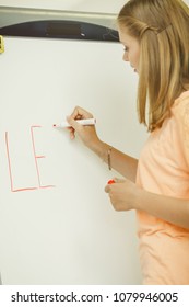 Education, knowledge, wisdom and learn new things concept - student girl writing Learning word on whiteboard inviting to join
