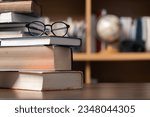 Education learning concept. Book in library with old open textbook, stack piles of literature text archive on reading desk, aisle of bookshelves in school study class room background for academic