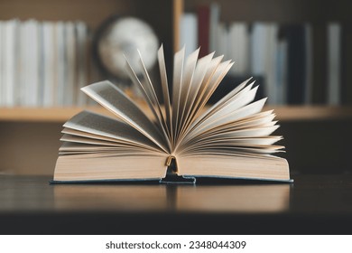 Education learning concept. Book in library with old open textbook, stack piles of literature text archive on reading desk, aisle of bookshelves in school study class room background for academic - Shutterstock ID 2348044309
