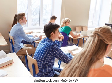 education, learning and people concept - group of students with notebooks at school lesson - Shutterstock ID 465469739