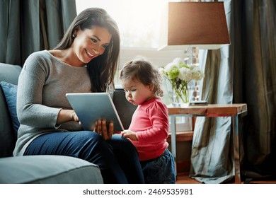 Education, mother and child with tablet in living room together for internet connection and development in home. Woman, kid or daughter with tech on couch for online learning and studying with love - Powered by Shutterstock