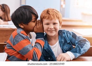 Education, naughty and secret with boy students in classroom together for learning or study. Gossip, question and whisper with children friends at desk in class for development, future or growth - Powered by Shutterstock