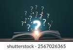 Education for new knowledge concept. Open book on wooden floor with question marks above. Questioning. Illustrating curiosity. Learning. Knowledge seeking. Read for problem solving.