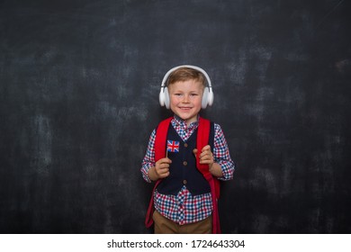 Education Online Language School For Kids. Happy Boy In Headphones With Bag And UK Flag