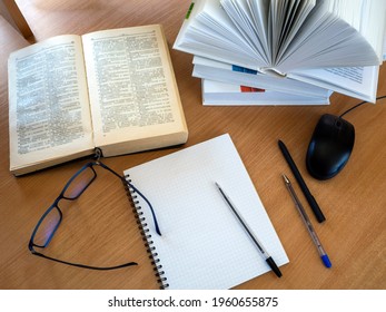Education process. Reading monographs, scientific literature, note-taking, educational process, online learning. Background with books and other items.
