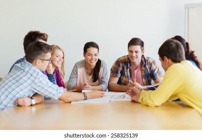 education, school, architecture and people concept - group of smiling students with blueprint meeting indoors - Powered by Shutterstock