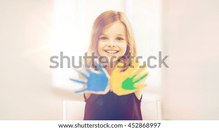 Similar – Foto Bild Mädchen mit bunt lackierten Fingernägeln, hält ein Eis in der Hand vor dem Mund.