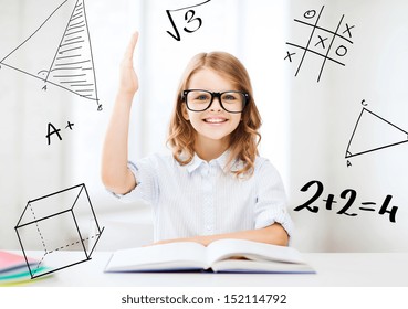 education and school concept - little student girl studying and raising hand at school - Powered by Shutterstock