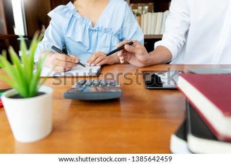 education and school concept, students campus or classmates learning tutoring catching up friend for a test or an exam in classroom.