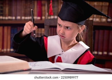 Education, school, knowledge and people concept. Funny portrait of young disappointed girl in graduation cap cannot write and study because the pen stopped working - Shutterstock ID 2250989977