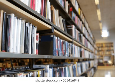 education, school, literature and knowledge concept - bookshelves with books at public library - Shutterstock ID 505416949