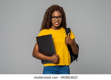 Education Series Template. Friendly Ethnic Black Woman High School Student Typing On Portable Computer With Thumbs Up Isolated On White Background