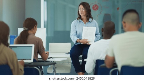 Education, students college professor with documents in classroom for lecture, learning and explain lesson. University, educator and diverse classmates for taking notes, knowledge or communication - Powered by Shutterstock