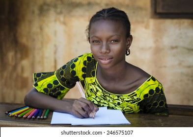 Education Symbol - African Girl Sitting On Her Desk Drawing