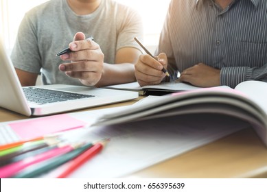 Education, teaching, learning, technology and people concept. Two high school students or classmates with helps friend catching up workbook learning in classroom, Tutor books with friends. - Shutterstock ID 656395639