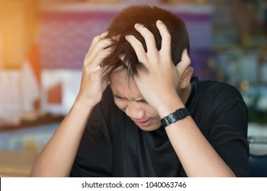 Education Test Concept : Asian Boy Student Studying Stressed Headaches For Exams In Classroom, Learning Lessons Doing Final Exam At High School.