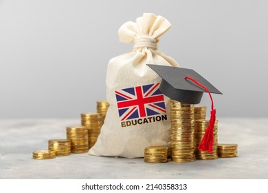Education in the UK. Expensive education. Stack of coins and graduate hat. - Shutterstock ID 2140358313