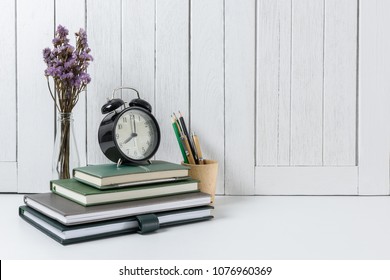 education workspace background concepts Pencil, stationery, flowers, Book, alarm clock White wooden vintage wall. back to school concepts - Powered by Shutterstock