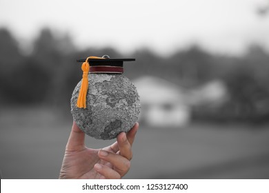 Education World Knowledge Ideas. Graduation Cap On Students Holding Gray Paper Mache Craft Earth Globe In Hands. Concept Of Global Business Study Abroad Inter Educational.Back To School