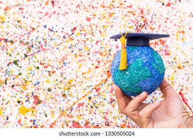 Education World Study Abroad Educational Knowledge Idea. Graduation Cap On Businessman Holding Paper Mache Craft Earth In Hand. Concept Of Graduate University On Water Colore Background,Back To School