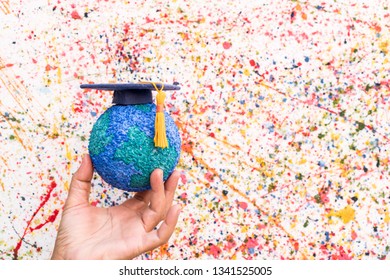 Education World Study Abroad Educational Knowledge Idea. Graduation Cap On Businessman Holding Paper Mache Craft Earth In Hand. Concept Of Graduate University On Water Colore Background,Back To School