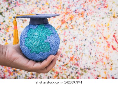 Education World Study Abroad Educational Knowledge Idea. Graduation Cap On Businessman Holding Paper Mache Craft Earth In Hand. Concept Of Graduate University On Water Colore Background,Back To School