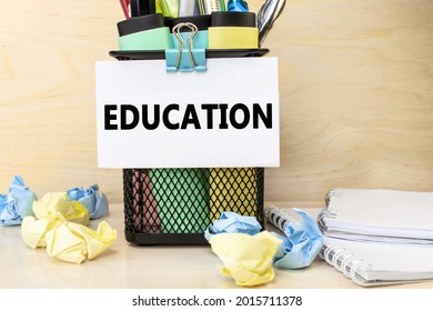 the education is written white sheet for notes that is attached to the organizer and stationery  A notebook   crumpled piece paper 
