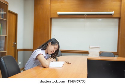 Educational And Business Concept; Girl Student Reading Books In A Study Room. Good Learning Environment.