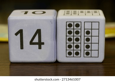 Educational foam math cubes displaying the number fourteen and visual dot arrays, commonly used for elementary math instruction, counting practice, and number recognition.