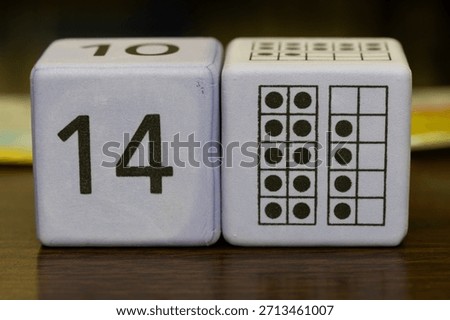 Educational foam math cubes displaying the number fourteen and visual dot arrays, commonly used for elementary math instruction, counting practice, and number recognition.