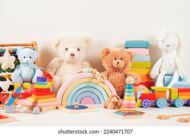 Educational kids toys collection. Teddy bear, wood plane, train, abacus, rainbow, wooden educational baby toys on white background. Sustainable, eco-friendly toys. Front view