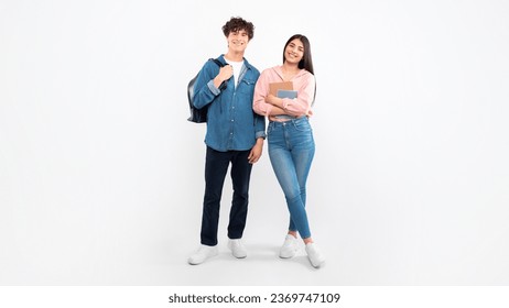 Educational Offer. Cheerful Young Students Duo Standing With Their Backpacks And Workbooks Over White Background. Full Length Studio Shot Of Boyfriend And Girlfriend Ready For College. Panorama - Powered by Shutterstock