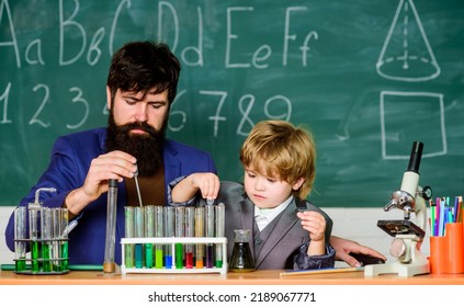 Educational School Program. Teacher And Child Test Tubes. School Lesson. Perseverance Pays Off. Chemical Experiment. Symptoms Of ADHD At School. Schoolboy Cute Child Experimenting With Liquids